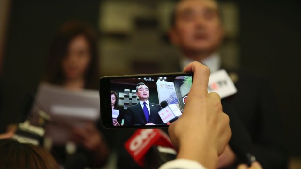 Chinese Foreign Minister Wang Yi speaks to journalists at the ASEAN foreign ministers' meeting in Manila on Sunday.