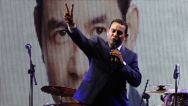 Television comedian and presidential candidate for the National Front of Convergence party Jimmy Morales, flashes a victory sign to his supporters after the first round of votes in September.