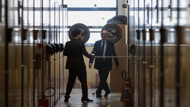 Carlos Nuzman, president of the Brazilian Olympic committee, walks in the hallway at Federal Police headquarters in Rio de Janeiro on Tuesday.