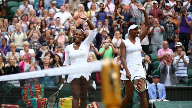 Victory salute: Venus and Serena Williams after match point.