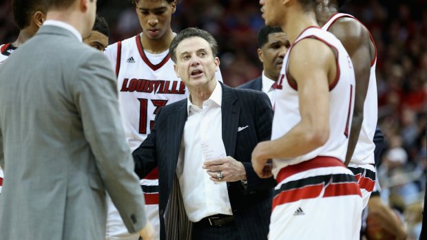 Banned: Rick Pitino gives instructions to his Louisville Cardinals team.