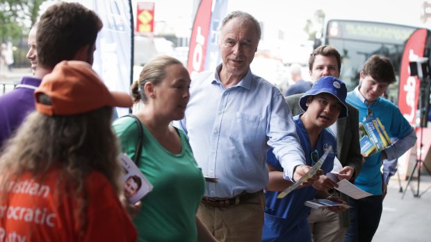 Liberal candidate for Bennelong John Alexander hands out how to vote cards.