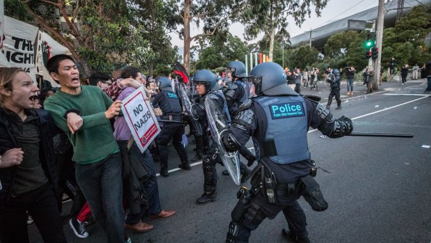 Police drive back protesters outside the Milo Yiannopoulos event in Melbourne.