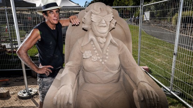 Sand sculptor Dennis Massoud with his tribute to Dame Edna Everage.