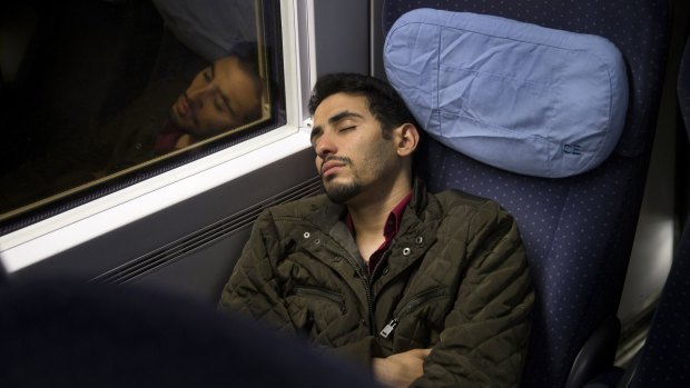 'I feel like a frog that's being dissected': Ayham al-Ahmad rests on a train bound for Berlin.