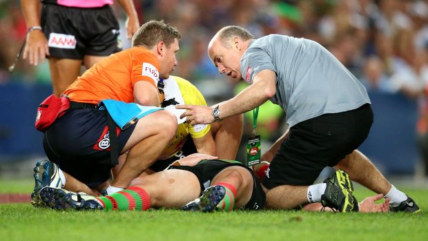 Down and out: Souths forward Dave Tyrrell is treated following a head clash with James Graham.