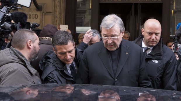 Cardinal George Pell leaves the Quirinale Hotel after meeting victims of sex abuse in March. 