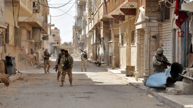 This photo from the Syrian state news agency SANA shows government soldiers in the streets of Palmyra. 