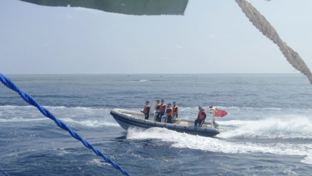 A Chinese Coast Guard boat circles a Filipino fishing boat near Scarborough Shoal in the South China Sea last year.  