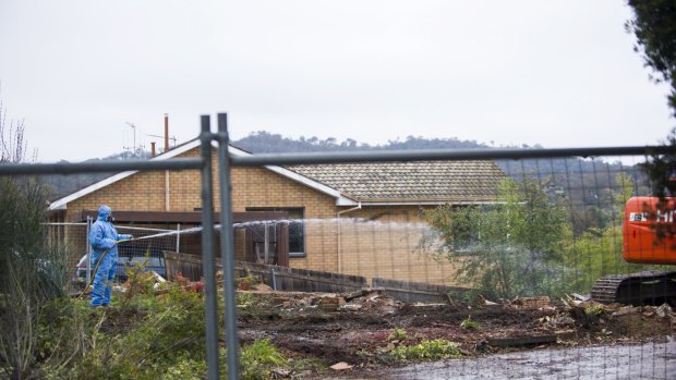 Gone: Workers demolish a Mr Fluffy home in Farrer.