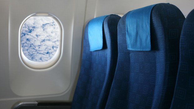 D8AKWM Airplane seat and window inside an aircraft