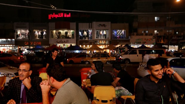 Normal life: Iraqis at a restaurant in the Karada district of the capital. 