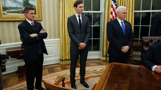 Jared Kushner, flanked by National Security Adviser Michael Flynn (left) and US Vice-President Mike Pence, watches his father-in-law Donald Trump sign his first executive order as US President.
