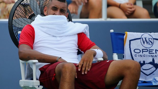 Cooling off: Nick Kyrgios takes a break between sets during his first round loss to Richard Gasquet in Cincinnati.