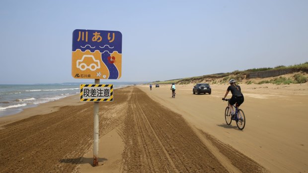 Cycling on a stretch of hard-packed sand at Chirihama Beach on the Noto Peninsula.