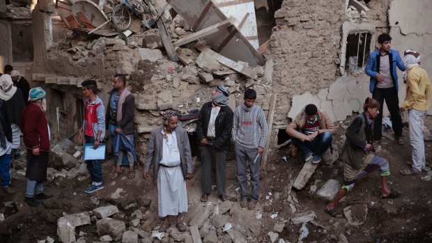 People gather at the site of a Saudi-led airstrike in Saana.