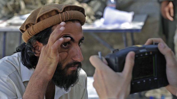 An Afghan man has his eye scanned for identification in Nangarhar province, bordering Pakistan.