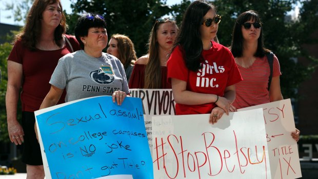 A group of survivors of sexual violence and their supporters protest proposed changes to Title IX before a speech by Education Secretary Betsy DeVos at George Mason University this month.