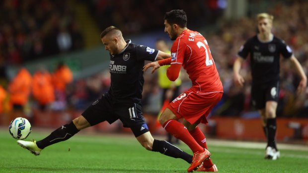 Burnley's Michael Kightly, right, holds off and Liverpool's Emre Can