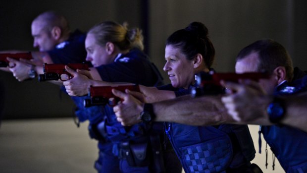 Victoria Police recruits in the firearms training simulator.