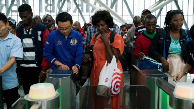 Chinese employees helped passengers to scan their tickets at the new Standard Gauge Railway terminal in Nairobi, Kenya.