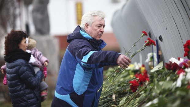Flowers are placed at the Volga-Dnepr Airlines headquarters in Ulyanovsk, Russia, on Monday after six Russians were killed during the Mali hotel attack.