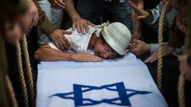 The grandmother of Israeli soldier Jordan Bensimon cries over his coffin in Ashkelon, Israel, during Operation Protective Edge.