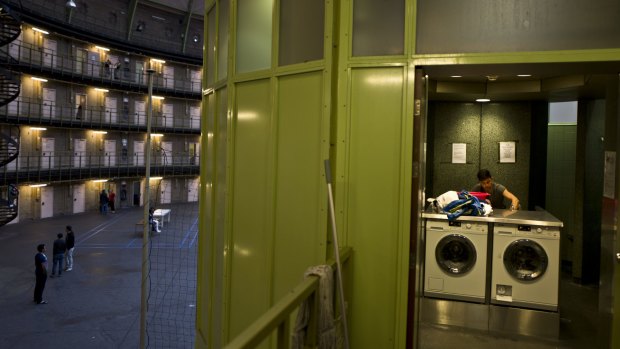 Afghan refugee Siratullah Hayatullah, 23, uses the common laundry in the former prison of De Koepel in Haarlem, Netherlands.  