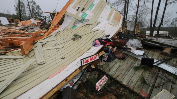 Parts of mobile homes and other property lay strewn throughout a neighbourhood in Lauderdale, Mississippi.