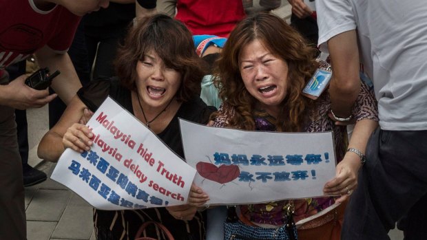 Chinese relatives of missing passengers protest at the Malaysian embassy in Beijing.