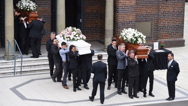 The coffins of Annabelle Falkholt and her parents Lars and Vivian Falkholt are carried out of St Mary's Catholic Church following their funeral at Concord, Sydney.