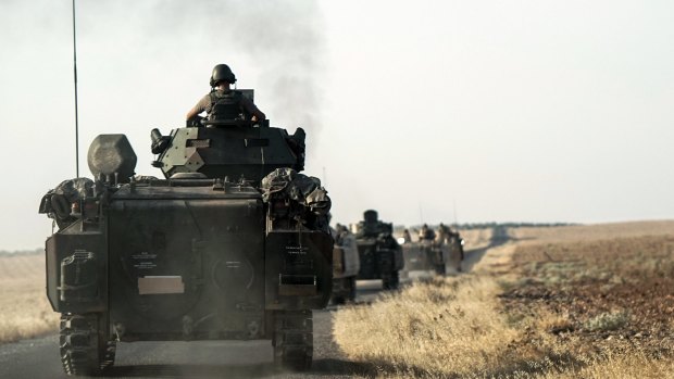 Turkish troops head for the Syrian border on August 27.