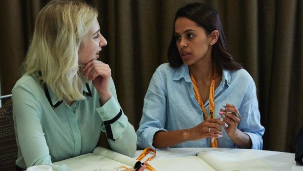 A CareerTrackers student and a trainer participating in a workshop.