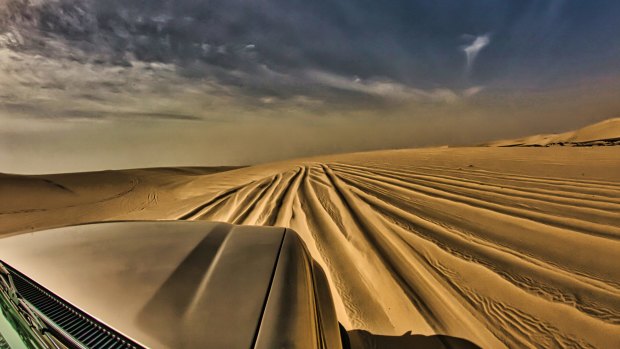 Teetering on the edge of a dune before the descent.