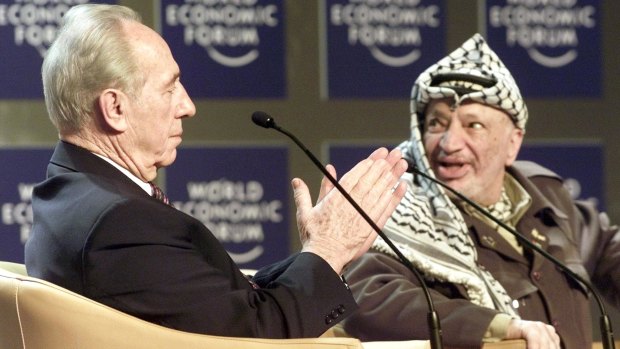 The late Palestinian leader Yasser Arafat, right, with former Israeli president and prime minister, the late Shimon Peres in 2001.