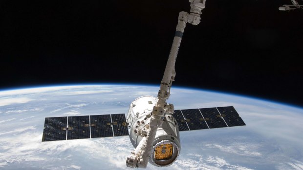 The SpaceX Dragon commercial cargo craft is grappled by the Canadarm2 robotic arm at the International Space Station in May 2012. 