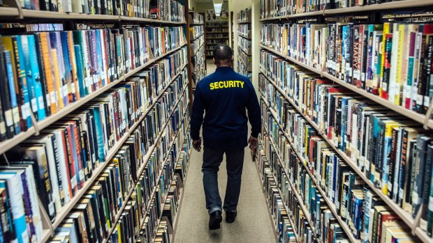 Will Hopper, a security guard, patrols the stacks at the Middletown Thrall Library in Middletown, New York state.