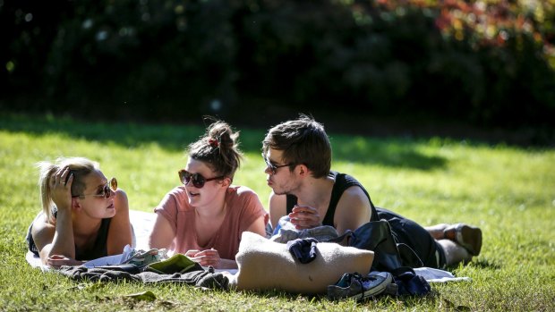 Hayley Smith, Felecity Hill and Filip Lindberg enjoys a warm Monday at the Treasury Gardens.