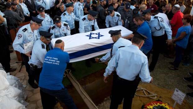 The body of Israeli police officer Yosef Kirma is laid to rest at the mount Herzl cemetery in Jerusalem on Sunday.
