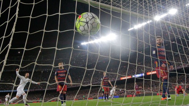 The winner: Barcelona goalkeeper Claudio Bravo, right, and Gerard Pique, 2nd right, watch the ball hit the net after Real Madrid's Cristiano Ronaldo scored the winning goal during a Spanish La Liga match against Barcelona at the Camp Nou stadium.