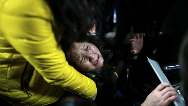 A woman grieves at a hospital where those injured by a stampede are being treated in Shanghai.