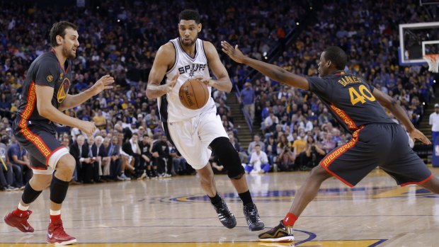 Ageing roster: San Antonio Spurs veteran Tim Duncan dribbles between Golden State Warriors defenders Andrew Bogut and Harrison Barnes during their clash in Oakland last week, won 110-99 by the Warriors.