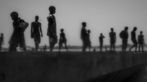  "Talibes, Modern Day Slaves" by Mario Cruz shows runaway talibes standing on the bank of Senegal river.