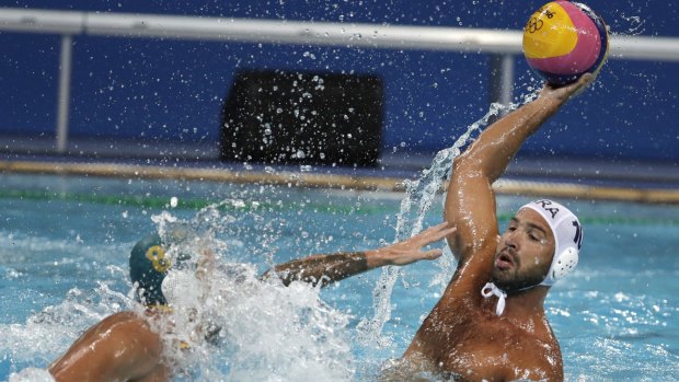 Brazil's Felipe Perrone, right, tries to pass the ball under pressure from Australia's Aaron Younger.
