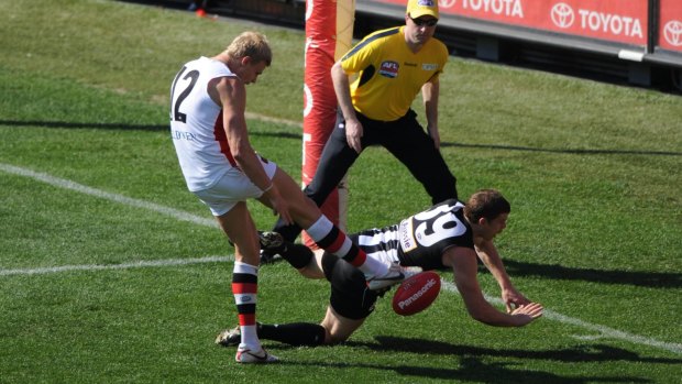 Collingwood's Heath Shaw throws his body over Nick Reiwoldt's boot to smother the ball and stop a goal in the grand final replay.