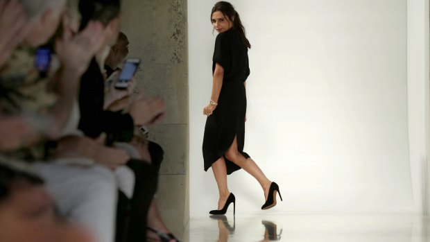 Designer Victoria Beckham acknowledges audience applause  after her Spring 2016 collection was modeled during Fashion Week in New York, Sunday, Sept. 13, 2015. (AP Photo/Richard Drew)