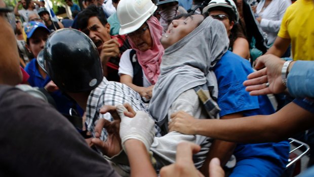A demonstrator wounded during clashes with security forces in Caracas this week.