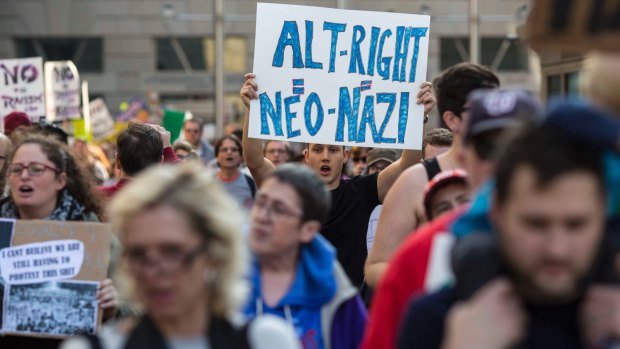Protesters march outside a conference of the so-called alt-right in Washington.