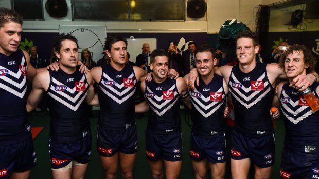 Taberner and Crozier (second and third from right) enjoy Fremantle's win against Carlton.
