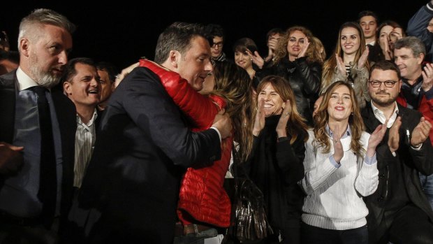 Former Italian Premier Matteo Renzi celebrates after winning the Democratic party's primary elections, in Rome.